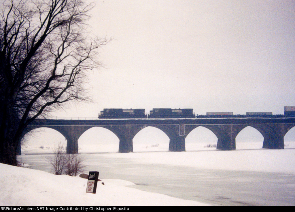 Two NS Dash-9s lead an intermodal across the Rockville Bridge in a snow storm